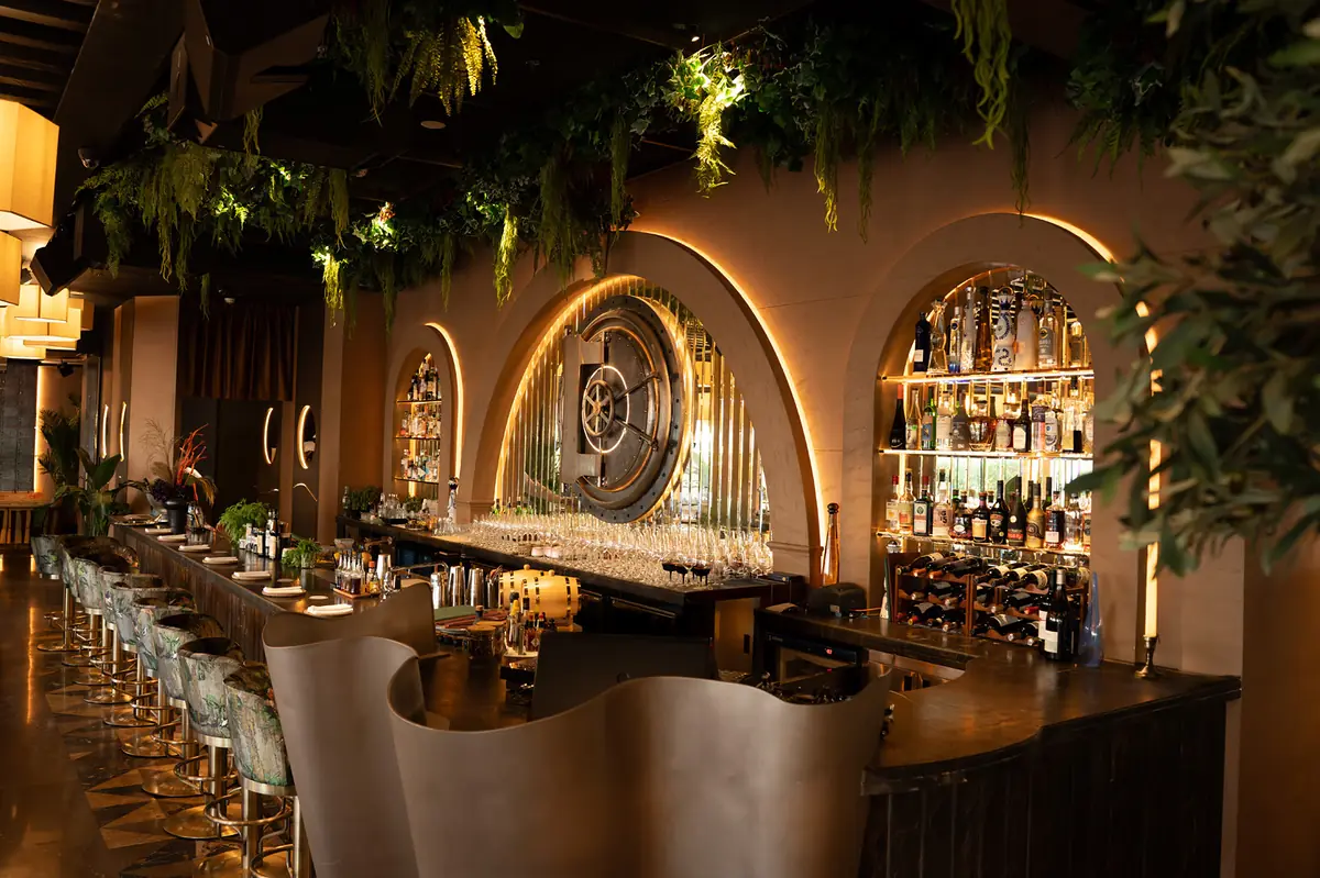 Banc Restaurant and Bar in Business Bay: the lit arches and vault door behind the bar, fitted out by MB Vision
