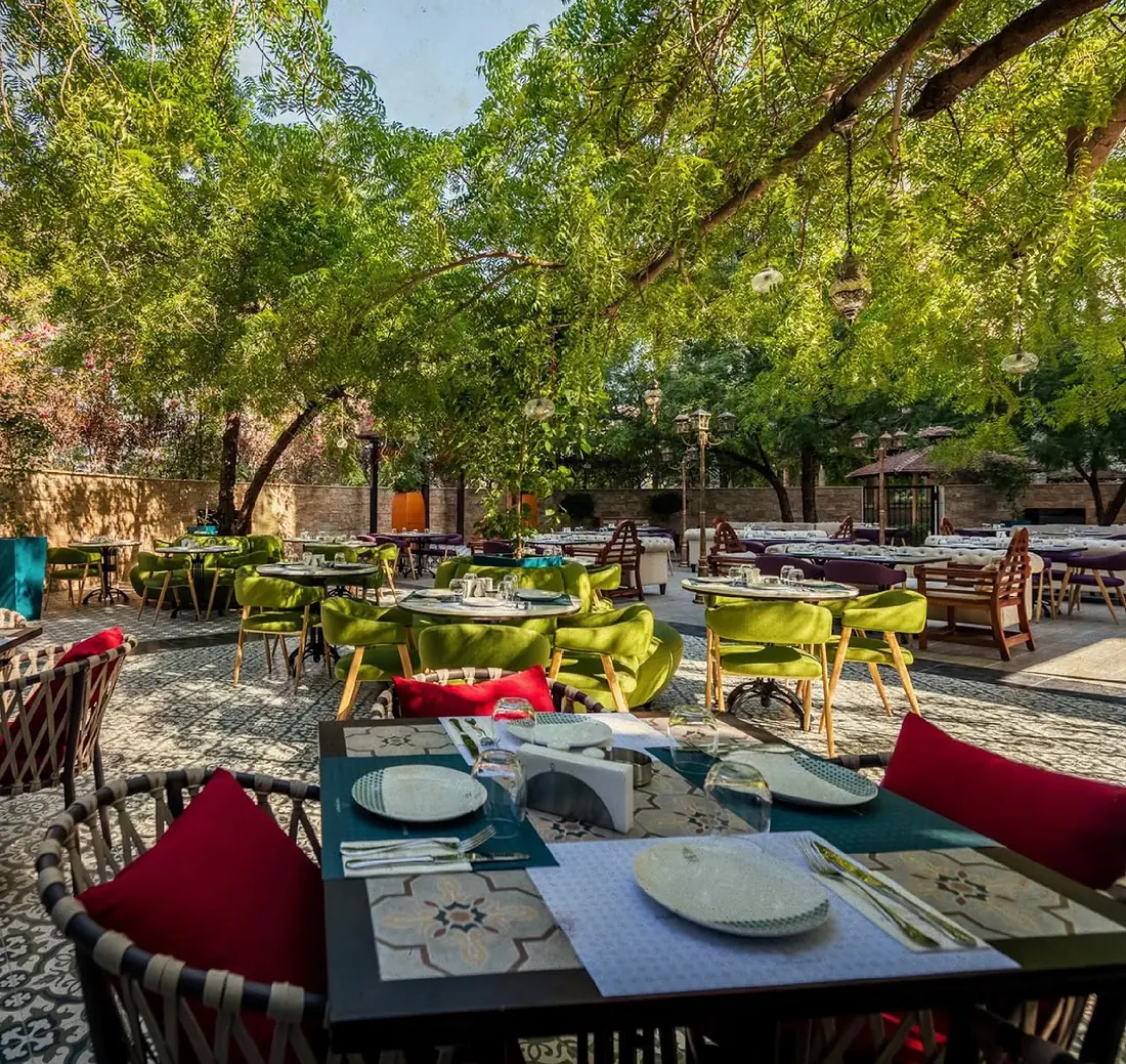 Coffee Beirut garden dining under the trees in Downtown Dubai