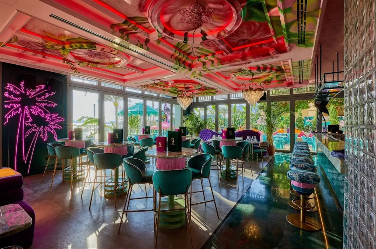 Black Flamingo bar with its painted ceiling at Palm West Beach