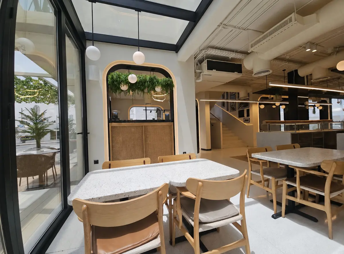 Juan Valdez cafe with a glass roof and timber seating in Abu Dhabi