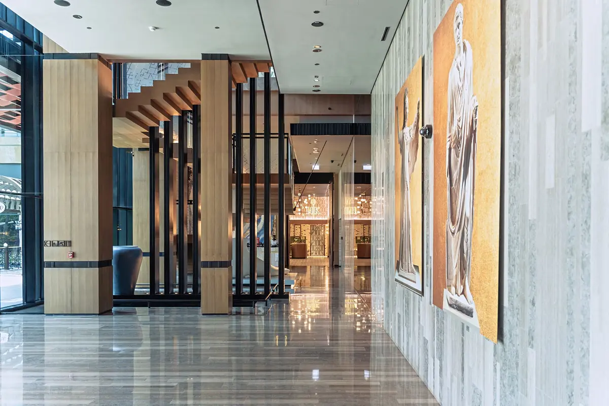 Bright hotel lobby with a marble floor and timber screens